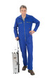 Portrait of automechanic standing with toolbox