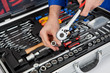 Portrait of automechanic taking a wrench out of toolbox