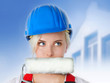 Young woman with building-site helmet and paint roller