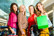 Four female friends shopping in a mall