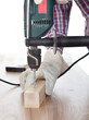 Worker drilling a hole in the wood