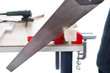 Worker cutting piece of timber