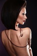 sexy nude brunette woman with jewelery and bright makeup