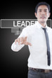 Businessman pushing Leader word on a touch screen interface.