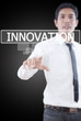 Businessman pushing Innovation word on a touch screen interface.