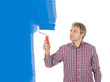 Senior adult painting wall in blue