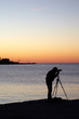 Photographer take a picture at sunset