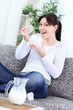 Happy young woman eating cornflakes