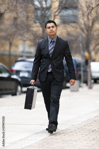 Photo: Hispanic Businessman - Walking Downtown With Briefcase Hispanic Businessman - Walking Downtown With Briefcase