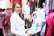 Young woman inside a store buying clothes