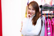 Young woman inside a store buying clothes