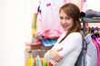 Young woman inside a store buying clothes