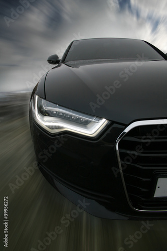 Photo: sports car goes on road sports car goes on road