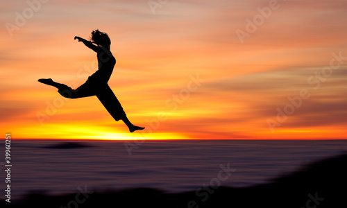Photo: silhouette of girl jumping in sunset silhouette of girl jumping in sunset