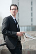 Young business man with newspaper.
