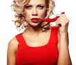 Sexy woman wearing red dress with chili pepper isolated on white