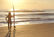 Woman Surfer In Bikini With Surfboard At Sunset Beach