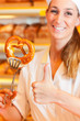 Salesperson is packing bread in bakery