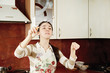 Woman conducting in kitchen