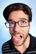 Young man modern nerd wide angle portrait blue background
