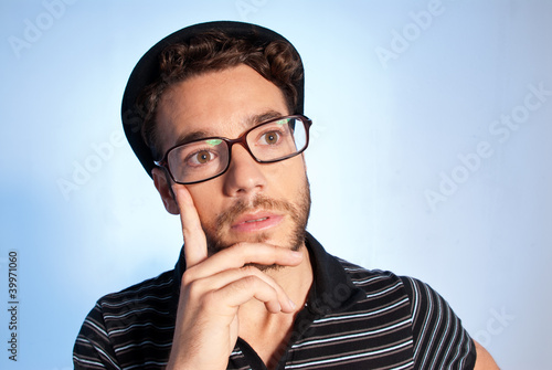 Photo: Young man modern nerd thinking wide angle portrait blue Young man modern nerd thinking wide angle portrait blue