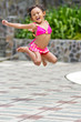 adorable ethnic child in swimsuit jump high adorable ethnic child in swimsuit jump high