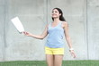 Pretty woman jumping with shopping bag in her hand