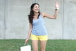 Happy woman in slow motion waving her hand and smiling