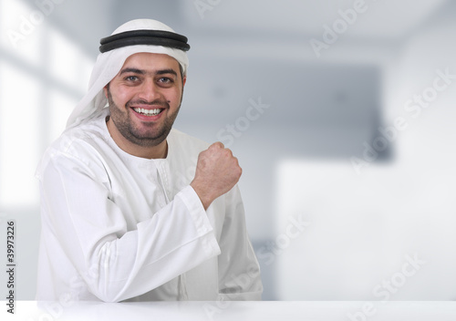 Photo: arabian businessman working in his office arabian businessman working in his office