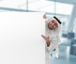 arabian businessman pointing at a blank sign with clipping path