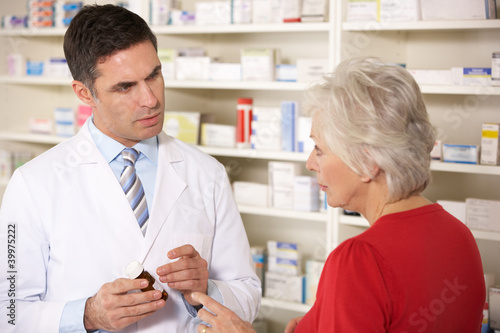 Photo: American pharmacist with senior woman in pharmacy American pharmacist with senior woman in pharmacy