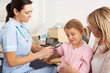 British nurse giving injection to young child