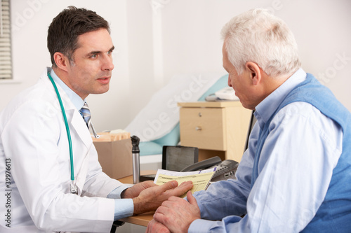 Photo: American doctor talking to senior man in surgery American doctor talking to senior man in surgery