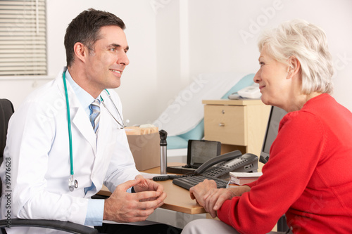 Photo: American doctor talking to senior woman in surgery American doctor talking to senior woman in surgery