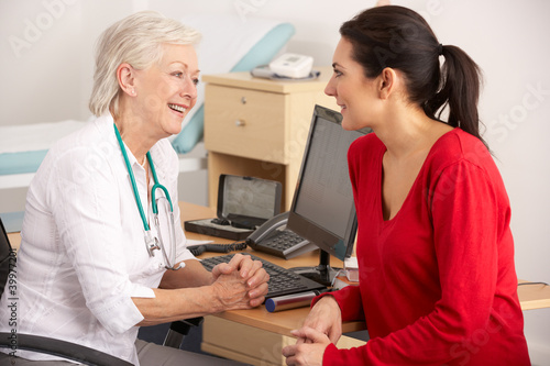 Photo: British GP talking to woman patient British GP talking to woman patient