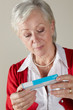 Senior woman looking at prescription drug pack