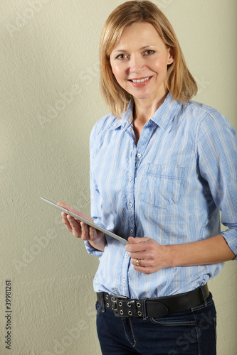 Photo: Studio Shot Of Middle Aged Woman Using Tablet Computer Studio Shot Of Middle Aged Woman Using Tablet Computer