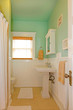 Photo: Small green bathroom with white sink. Small green bathroom with white sink.