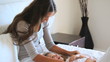 Young mother tickling her daughter