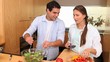 Video: Couple preparing a salad with peppers Couple preparing a salad with peppers