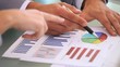 Close-up of people using graphs