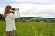 Photo: Woman looking in binoculars. Woman looking in binoculars.