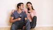 Video: Smiling couple sitting down while clinking their glasses Smiling couple sitting down while clinking their glasses