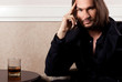 Attractive young guy with glass of scotch whiskey
