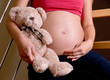 pregnancy. pregnant woman is holding teddy bear