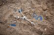 Old alarm-clock covered by layer of sandy soil