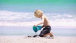 Blonde child playing with a shovel
