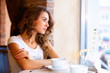 Young pretty woman sitting in restaurant