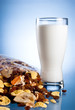 Fresh Glass of Milk and Closed Pack of muesli on a blue backgrou