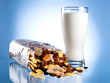 Fresh Glass of Milk and Opened Pack of muesli on a blue backgrou